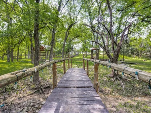 a view of a street with large trees