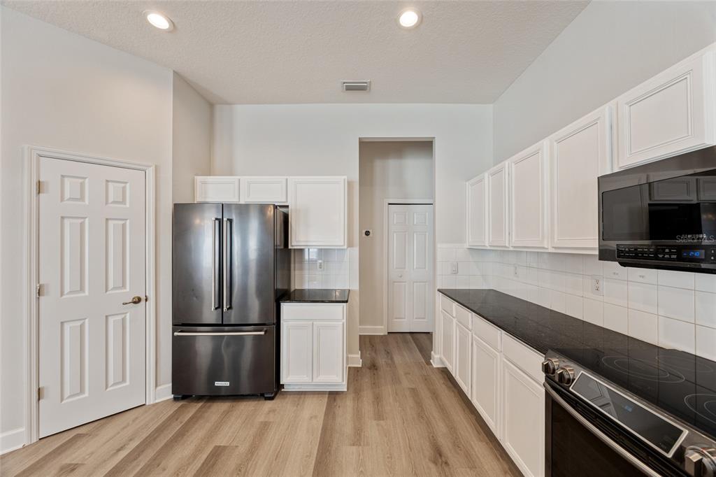 4925 Brightstone Place Spring Hill, FL 34609 - Photo 12 of 40 a kitchen with a refrigerator and a sink