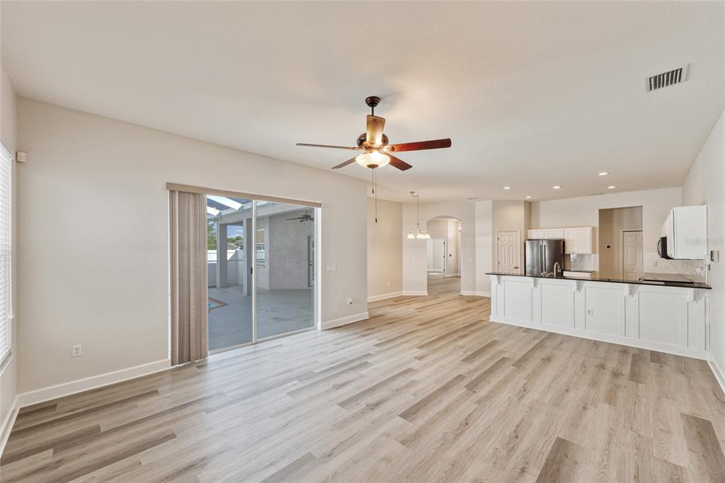 4925 Brightstone Place Spring Hill, FL 34609 - Photo 13 of 40 a large kitchen with cabinets wooden floor and a sink