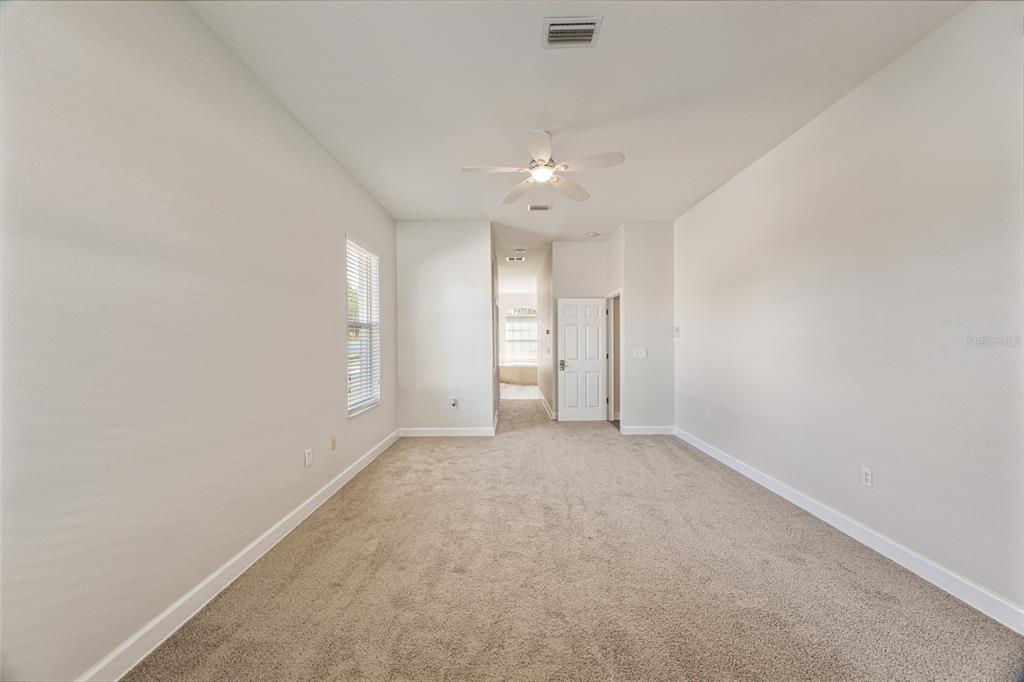 4925 Brightstone Place Spring Hill, FL 34609 - Photo 16 of 40 an empty room with a cabinet and a window