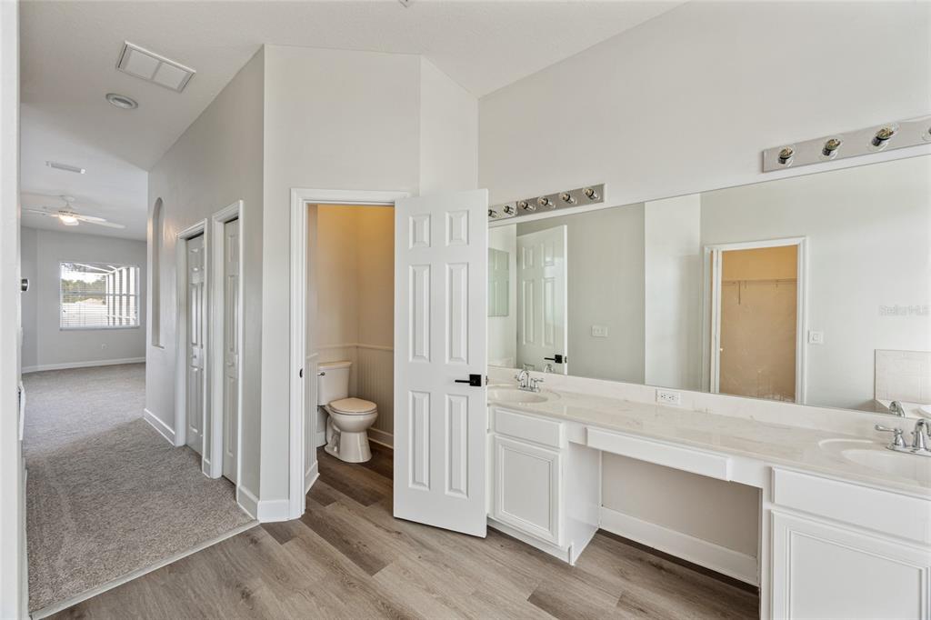 4925 Brightstone Place Spring Hill, FL 34609 - Photo 17 of 40 a bathroom with a double vanity sink and a mirror