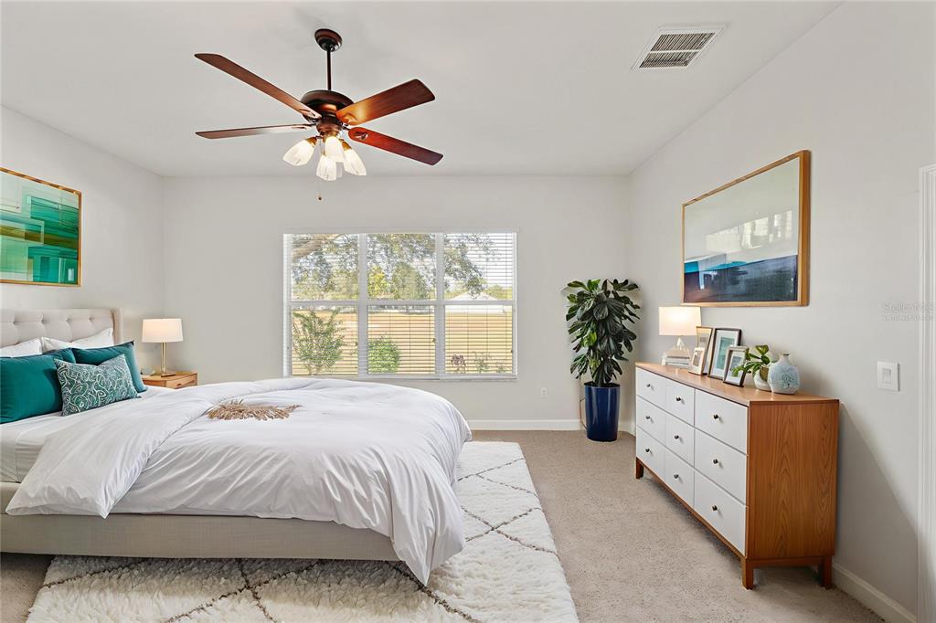 4925 Brightstone Place Spring Hill, FL 34609 - Photo 20 of 40 a bedroom with a large bed and a window