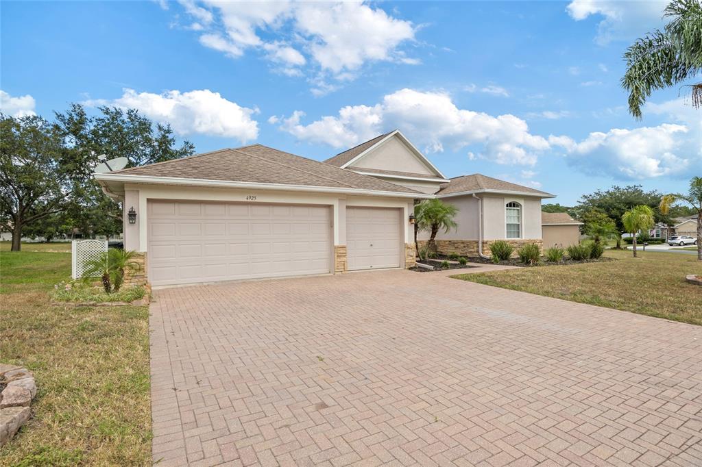 4925 Brightstone Place Spring Hill, FL 34609 - Photo 2 of 40 a front view of a house with a yard and garage