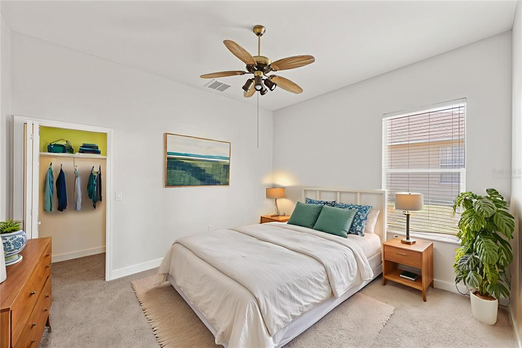 4925 Brightstone Place Spring Hill, FL 34609 - Photo 23 of 40 a bedroom with a bed and a chandelier