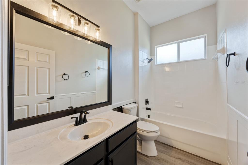 4925 Brightstone Place Spring Hill, FL 34609 - Photo 25 of 40 a bathroom with a sink a toilet and shower