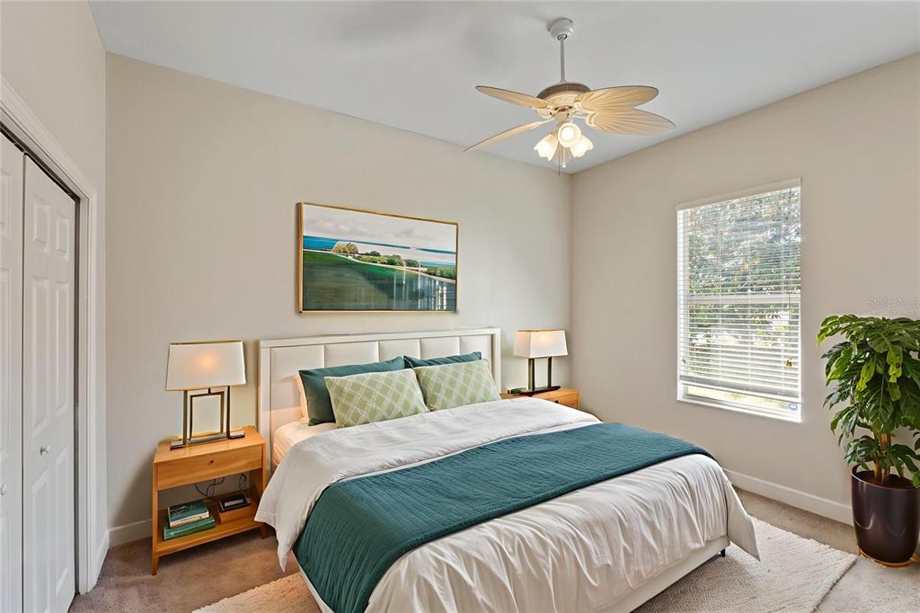 4925 Brightstone Place Spring Hill, FL 34609 - Photo 26 of 40 a bedroom with a bed and a chandelier
