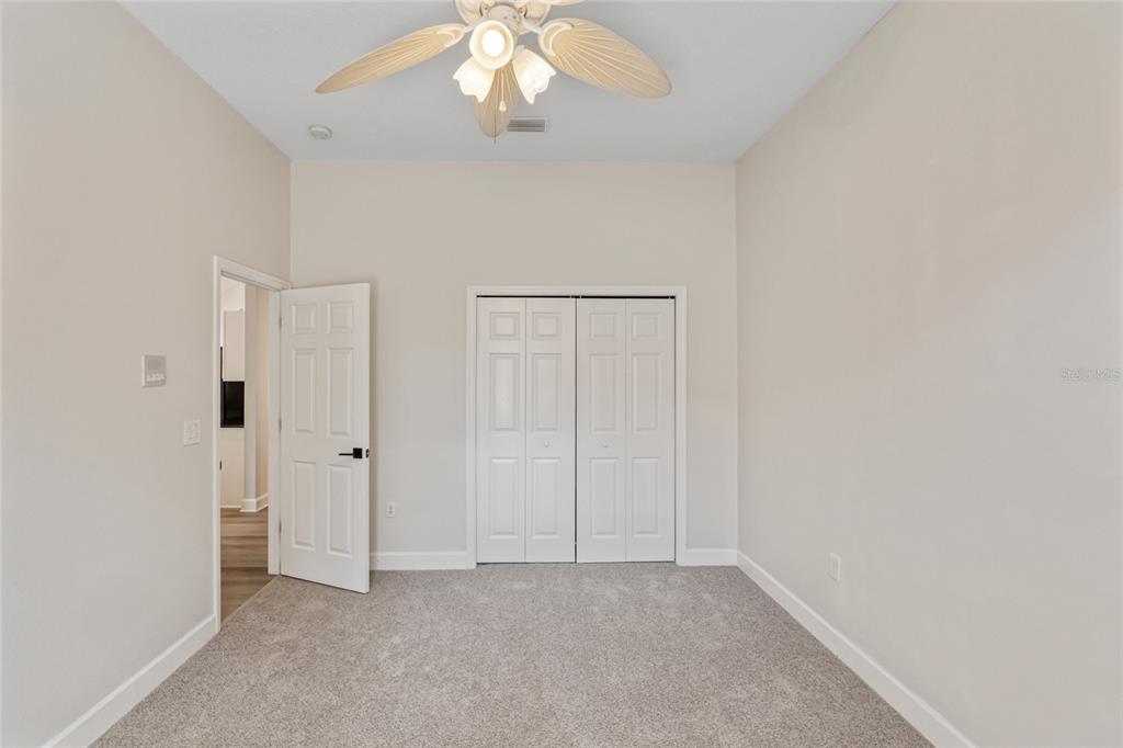 4925 Brightstone Place Spring Hill, FL 34609 - Photo 27 of 40 an empty room with a chandelier fan