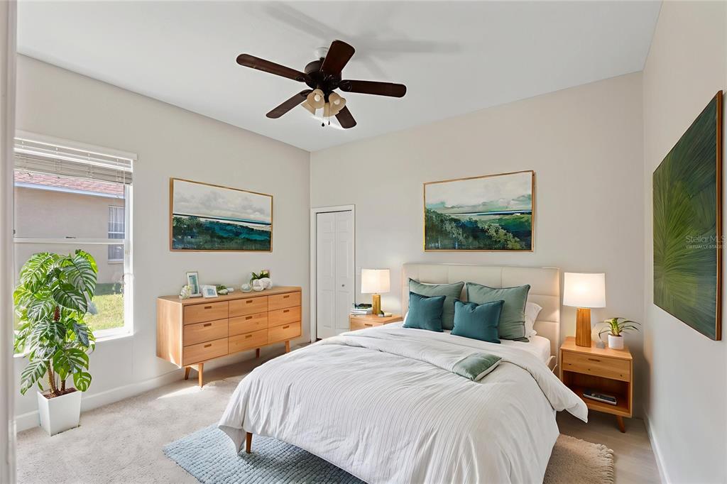 4925 Brightstone Place Spring Hill, FL 34609 - Photo 28 of 40 a bedroom with a bed and a flat screen tv