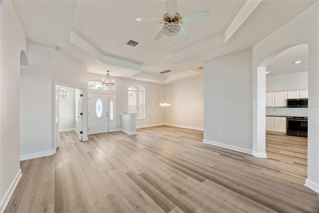 4925 Brightstone Place Spring Hill, FL 34609 - Photo 4 of 40 a view of an empty room with wooden floor