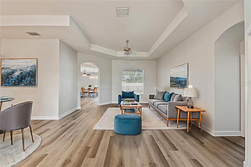 4925 Brightstone Place Spring Hill, FL 34609 - Photo 5 of 40 a living room with furniture and a wooden floor