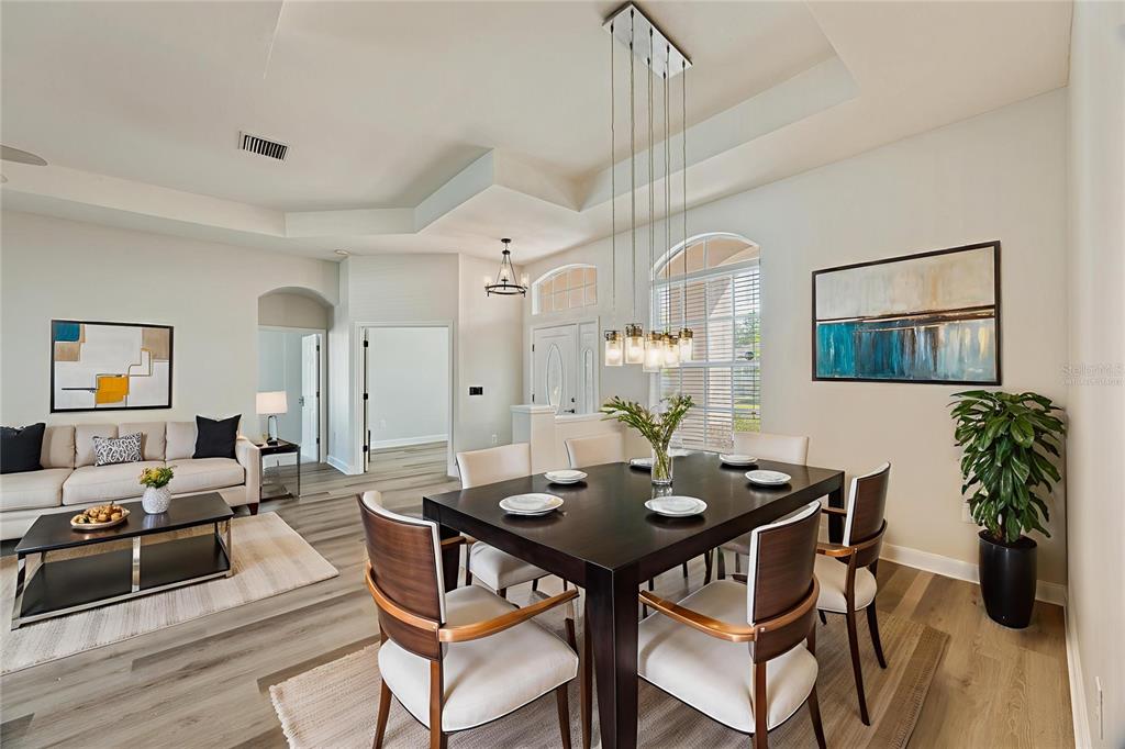 4925 Brightstone Place Spring Hill, FL 34609 - Photo 6 of 40 a view of a dining room with furniture and wooden floor