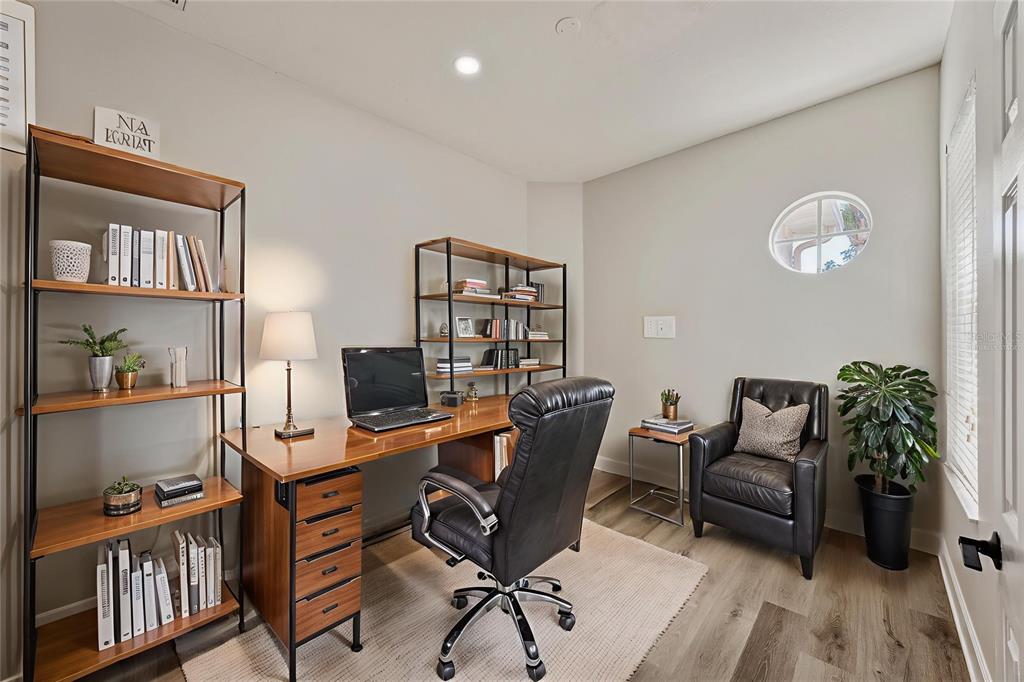 4925 Brightstone Place Spring Hill, FL 34609 - Photo 8 of 40 a work room with furniture and wooden floor