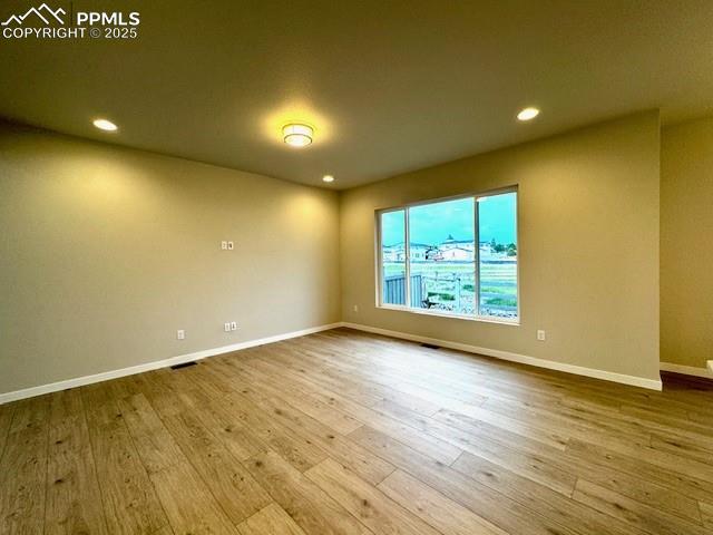 17737 Lemon Rye Loop Monument, CO 80132 - Photo 5 of 14 an empty room with wooden floor and windows