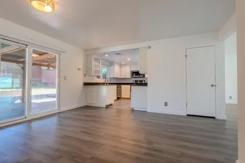 a view of a kitchen with wooden floor and a kitchen