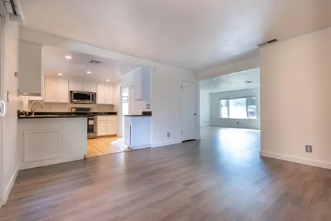a view of kitchen with cabinets and wooden floor