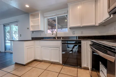 a kitchen with stainless steel appliances granite countertop a sink and cabinets