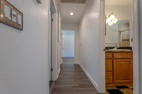 a view of a hallway with wooden floor