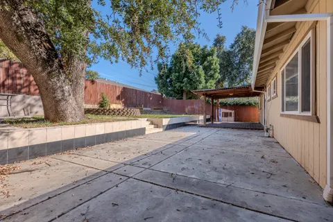 a view of house with outdoor space and sitting area