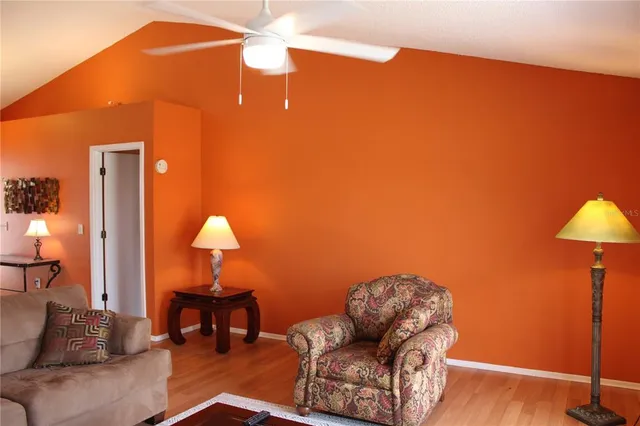 a living room with furniture a lamp and a lamp