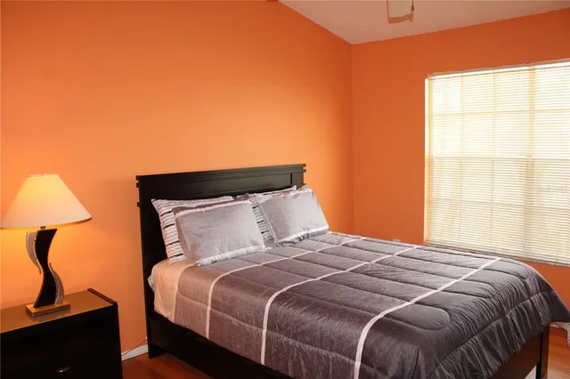 a bedroom with a bed and a window