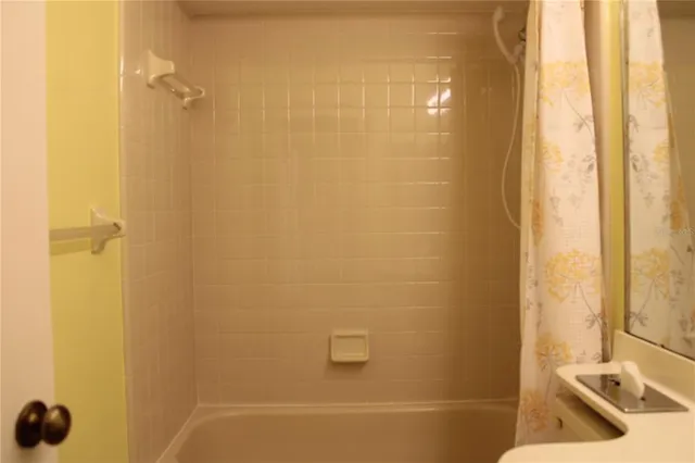 a bathroom with a tub and a shower