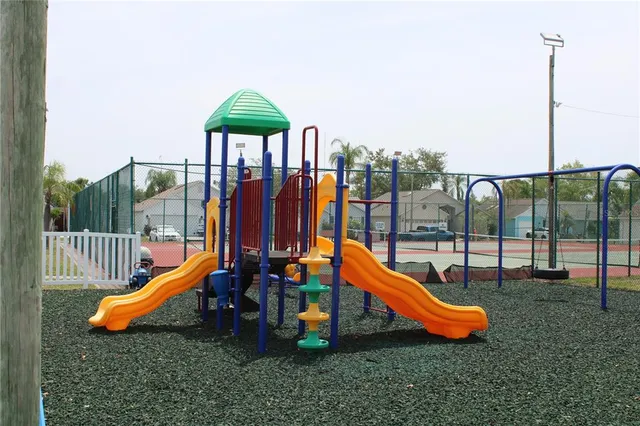 a backyard with swimming pool and outdoor seating