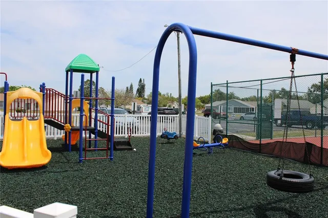 a view of a garden with a slide and a lake view
