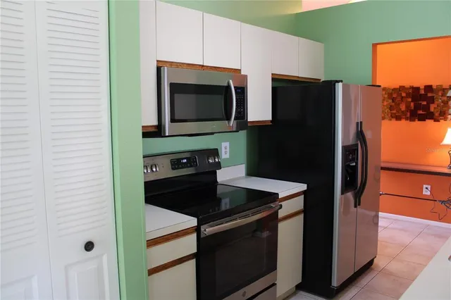 a kitchen with a refrigerator and a microwave