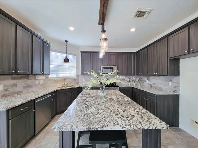a kitchen with a refrigerator and a sink