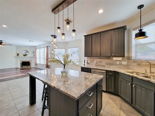 a kitchen with a stove sink and cabinets