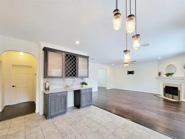 a view of an empty room with window and fire place