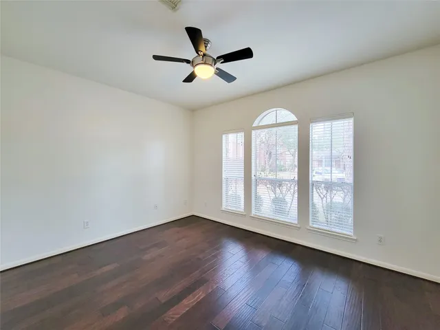 a view of living room kitchen with a sink and dishwasher with wooden floor