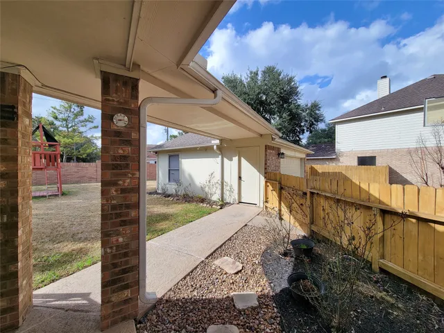 a view of a pathway of a house with a yard