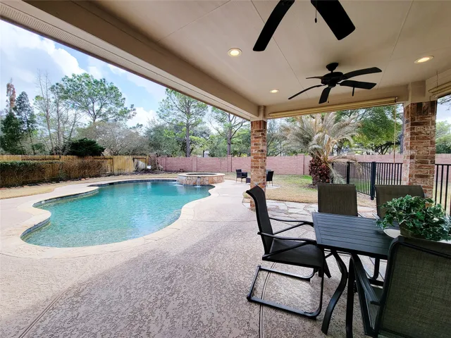 a dining room with furniture and a floor to ceiling window