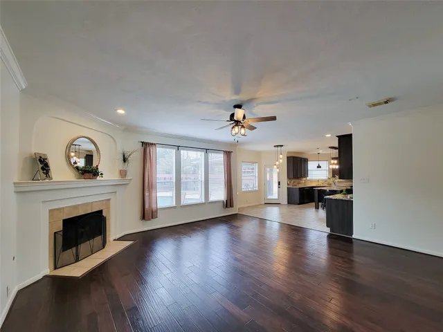 a view of empty room with wooden floor and fireplace