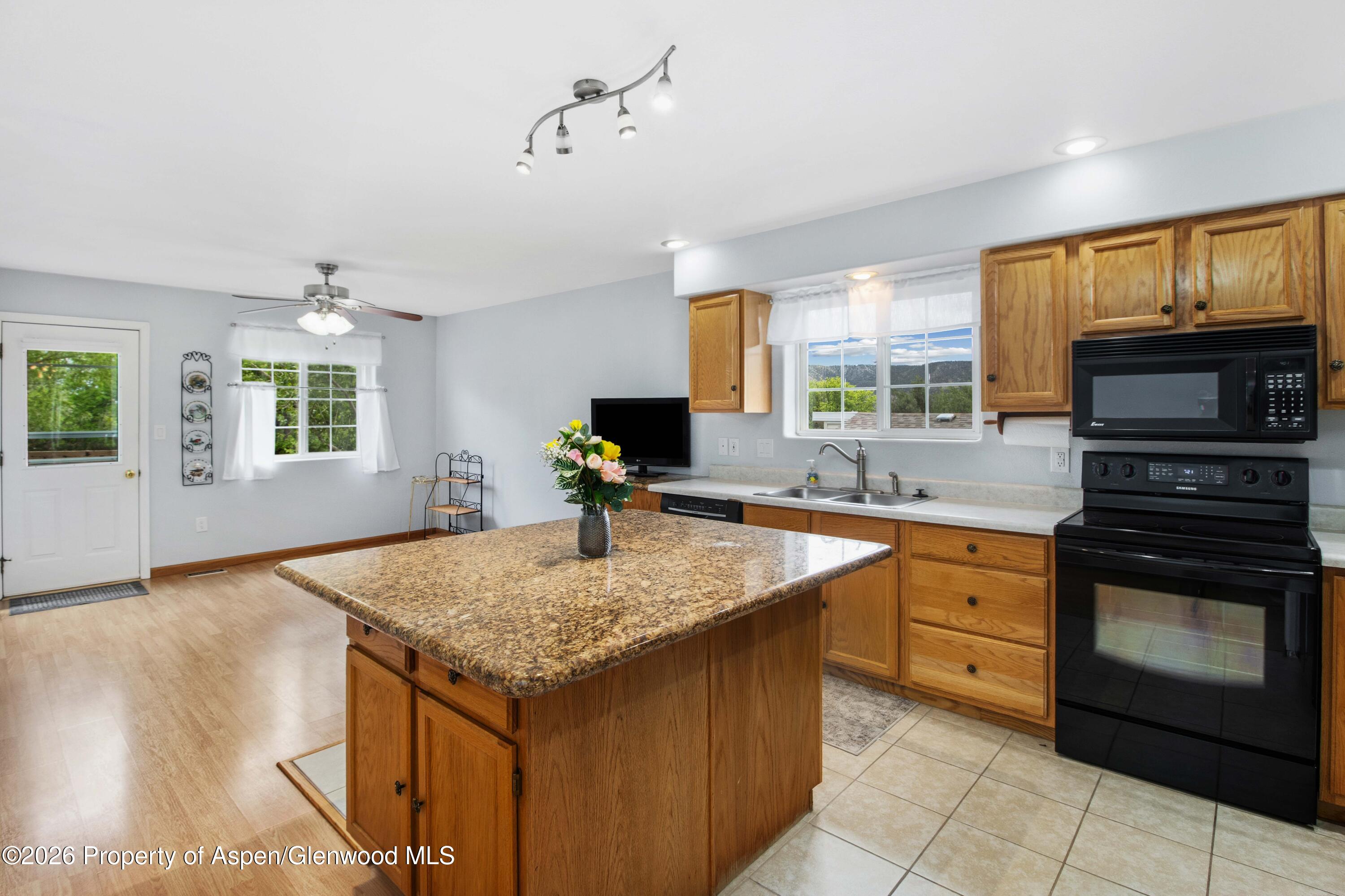 660 Aspen Avenue Rifle, CO 81650 - Photo 8 of 30 a kitchen with a stove a sink and a refrigerator