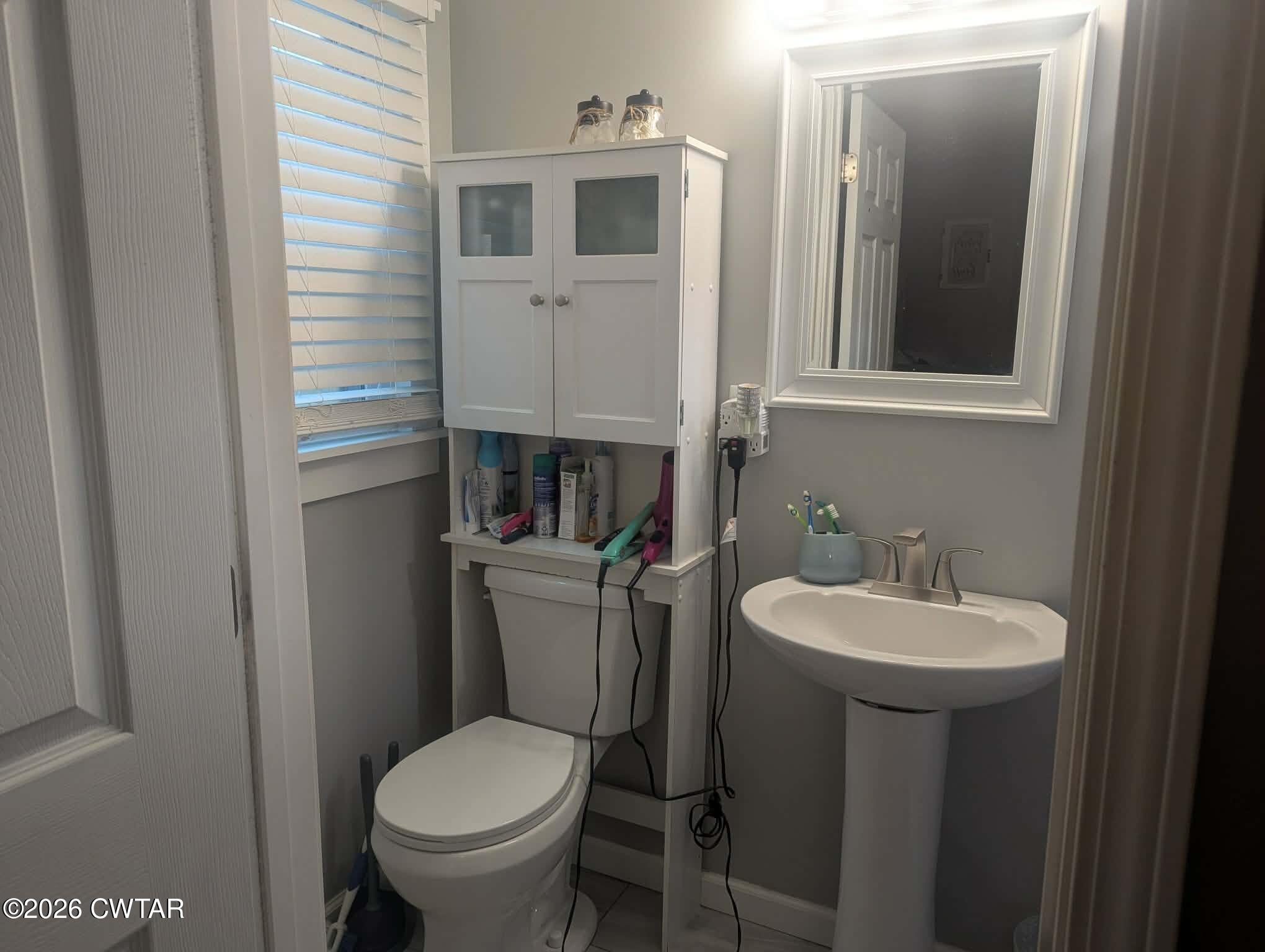 4072 Beech Bluff Road Beech Bluff, TN 38313 - Photo 24 of 51 a bathroom with a toilet sink and mirror