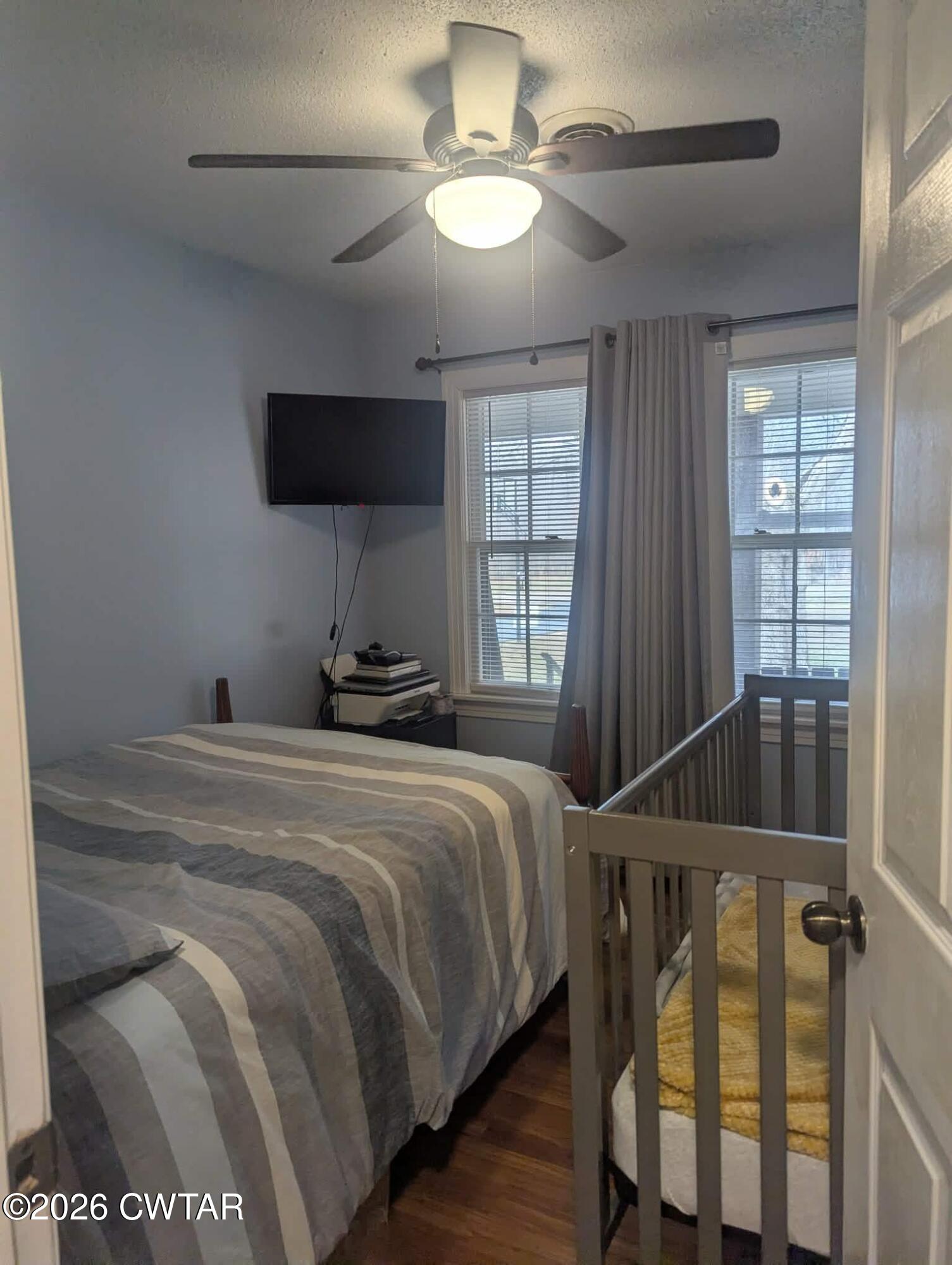 4072 Beech Bluff Road Beech Bluff, TN 38313 - Photo 27 of 51 a bedroom with a bed and a chandelier