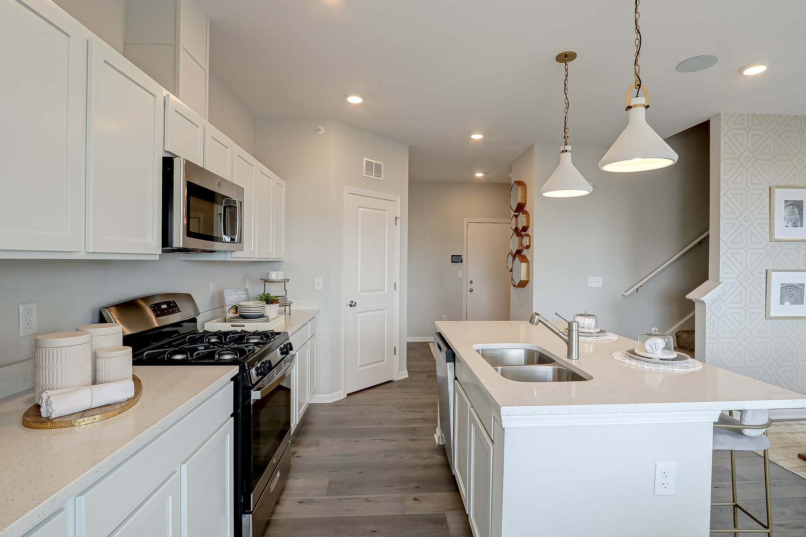475 Comstock Road South Elgin, IL 60177 - Photo 12 of 31 a kitchen that has a sink a microwave oven a stove and a center island with wooden floor