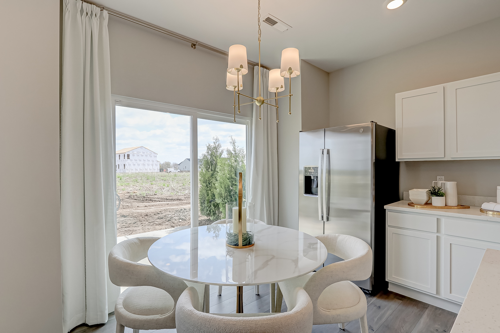 475 Comstock Road South Elgin, IL 60177 - Photo 8 of 31 a kitchen with stainless steel appliances granite countertop a refrigerator a sink a dining table and chairs