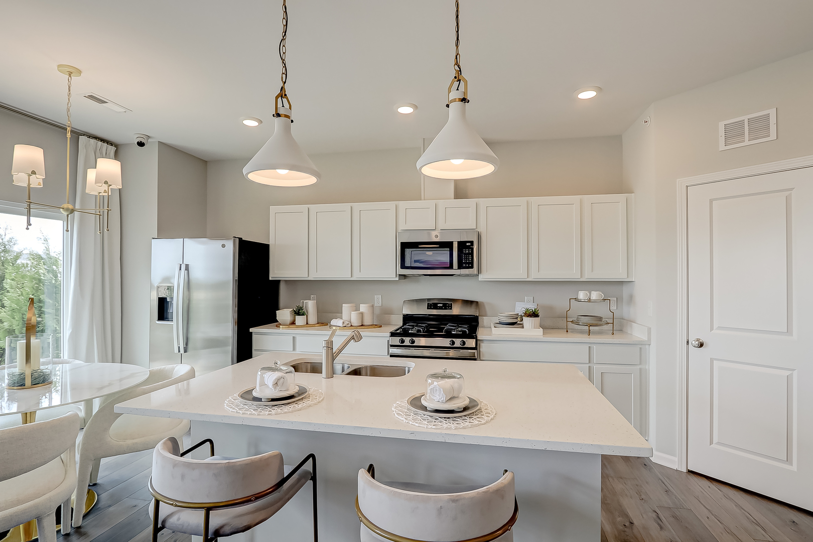 475 Comstock Road South Elgin, IL 60177 - Photo 9 of 31 a kitchen with stainless steel appliances granite countertop a sink a stove a refrigerator and white cabinets with wooden floor