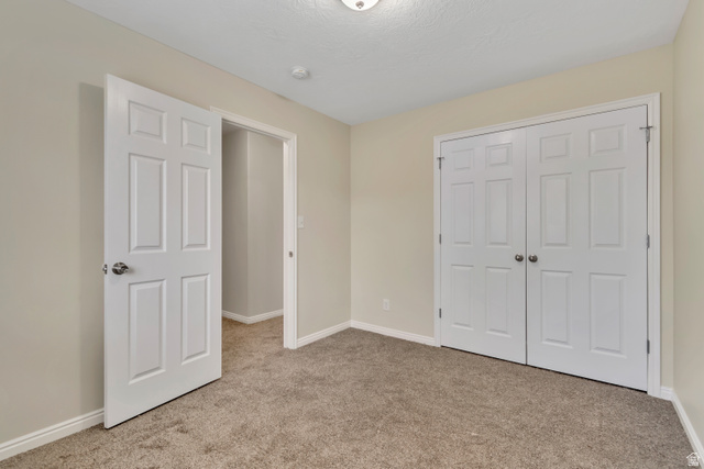 1118 North Ridge Court Spanish Fork, UT 84660 - Photo 15 of 32 Unfurnished bedroom featuring light carpet and a closet