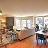 a living room with furniture dining table and a large window