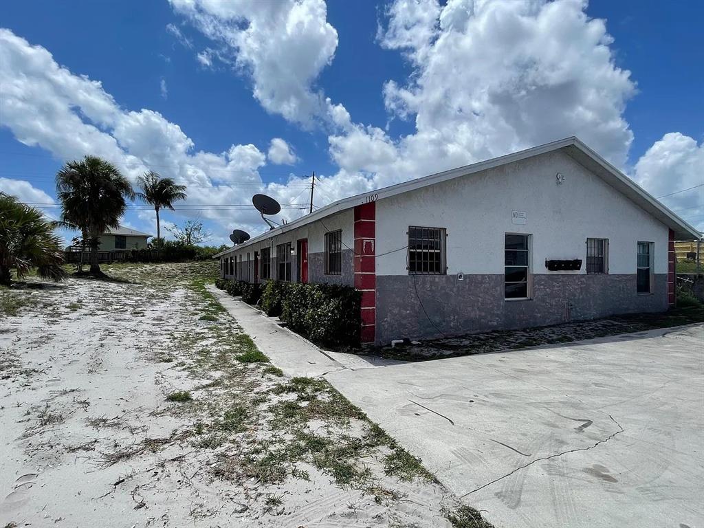 1109 West 28th Street, Unit 4 Riviera Beach, FL 33404 - Photo 12 of 12 a front view of a house with a yard
