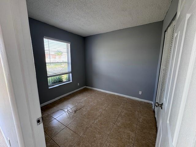 1109 West 28th Street, Unit 4 Riviera Beach, FL 33404 - Photo 10 of 12 an empty room with windows