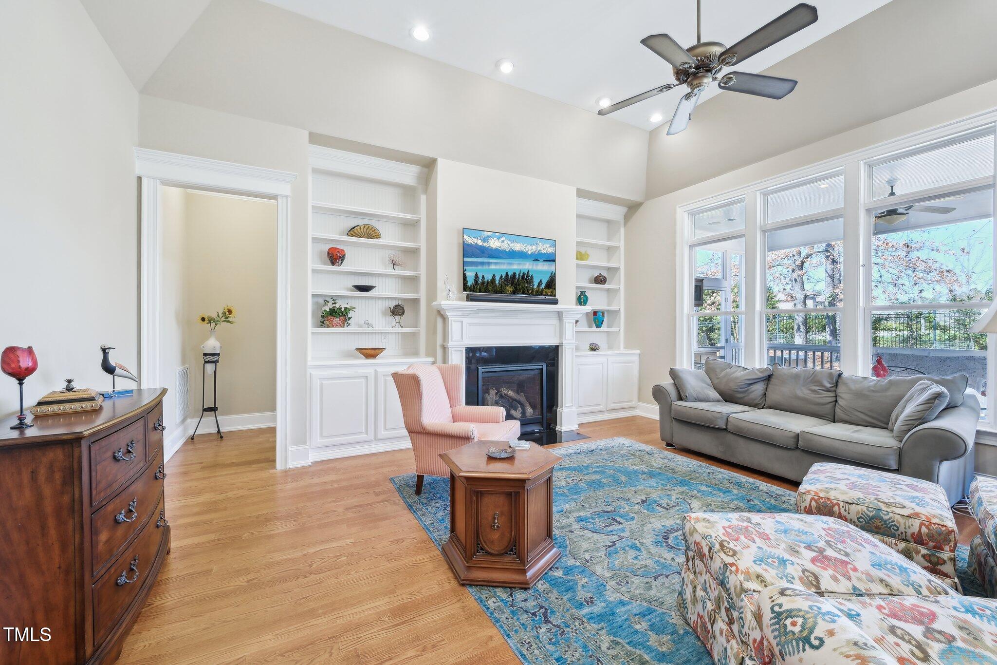 301 Kinsale Drive Durham, NC 27707 - Photo 9 of 68 a living room with furniture a flat screen tv and a fireplace