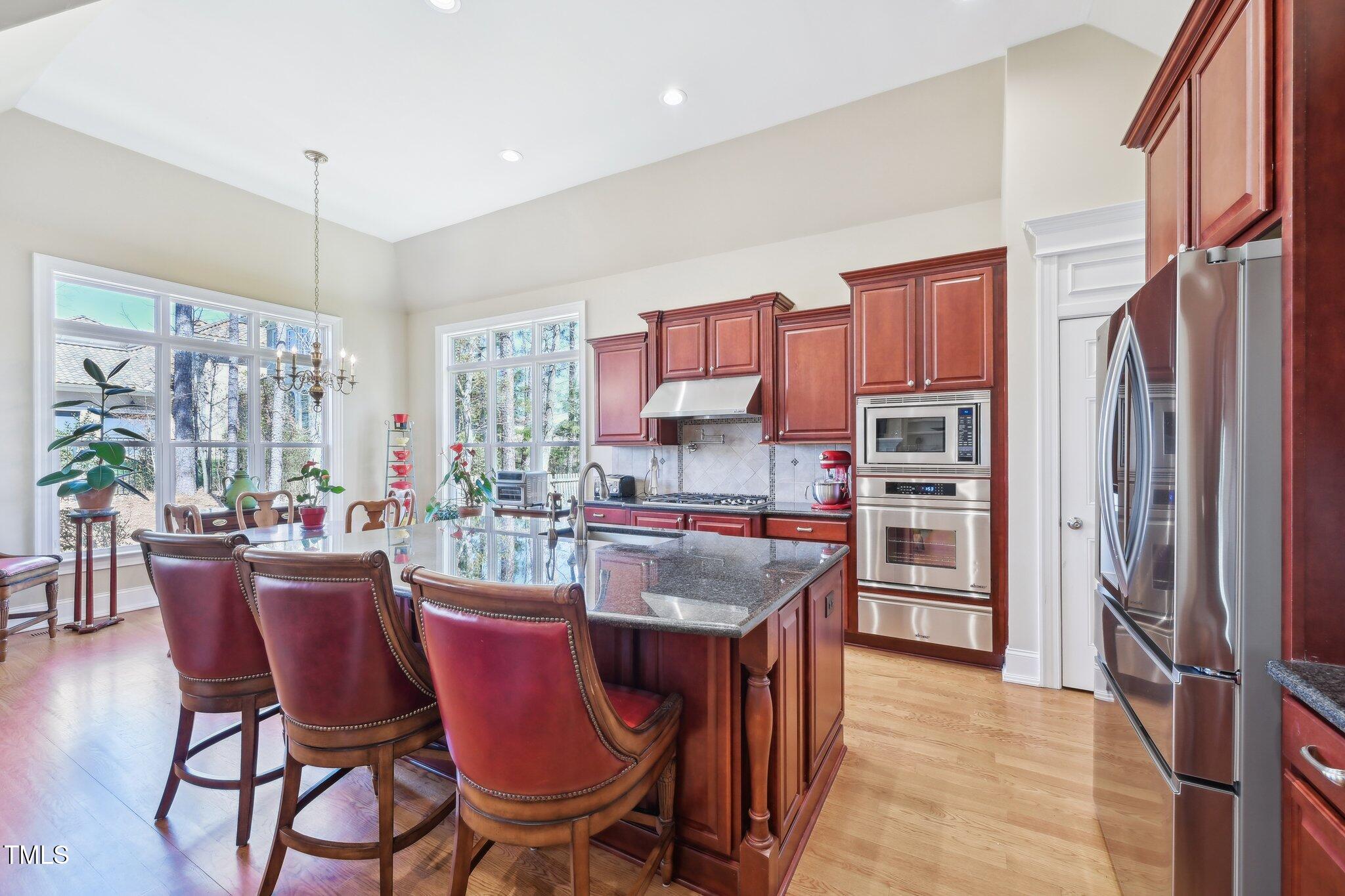 301 Kinsale Drive Durham, NC 27707 - Photo 16 of 68 a dining room with furniture a window and kitchen view