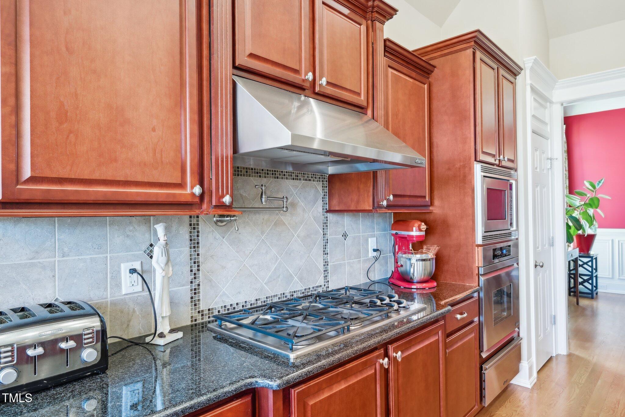 301 Kinsale Drive Durham, NC 27707 - Photo 18 of 68 a kitchen with stainless steel appliances granite countertop a stove and a wooden cabinets