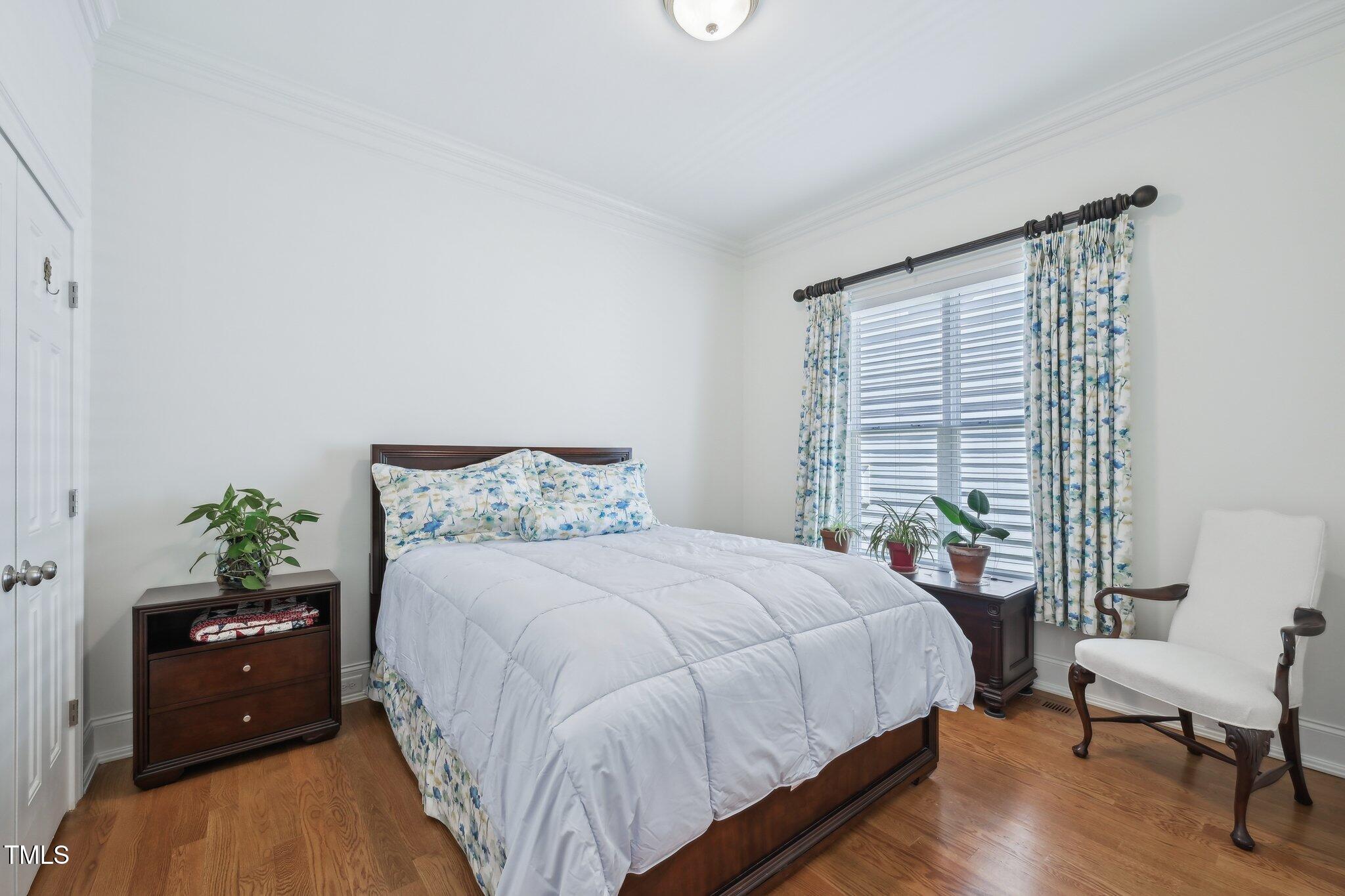301 Kinsale Drive Durham, NC 27707 - Photo 27 of 68 a bedroom with a bed and window with chair