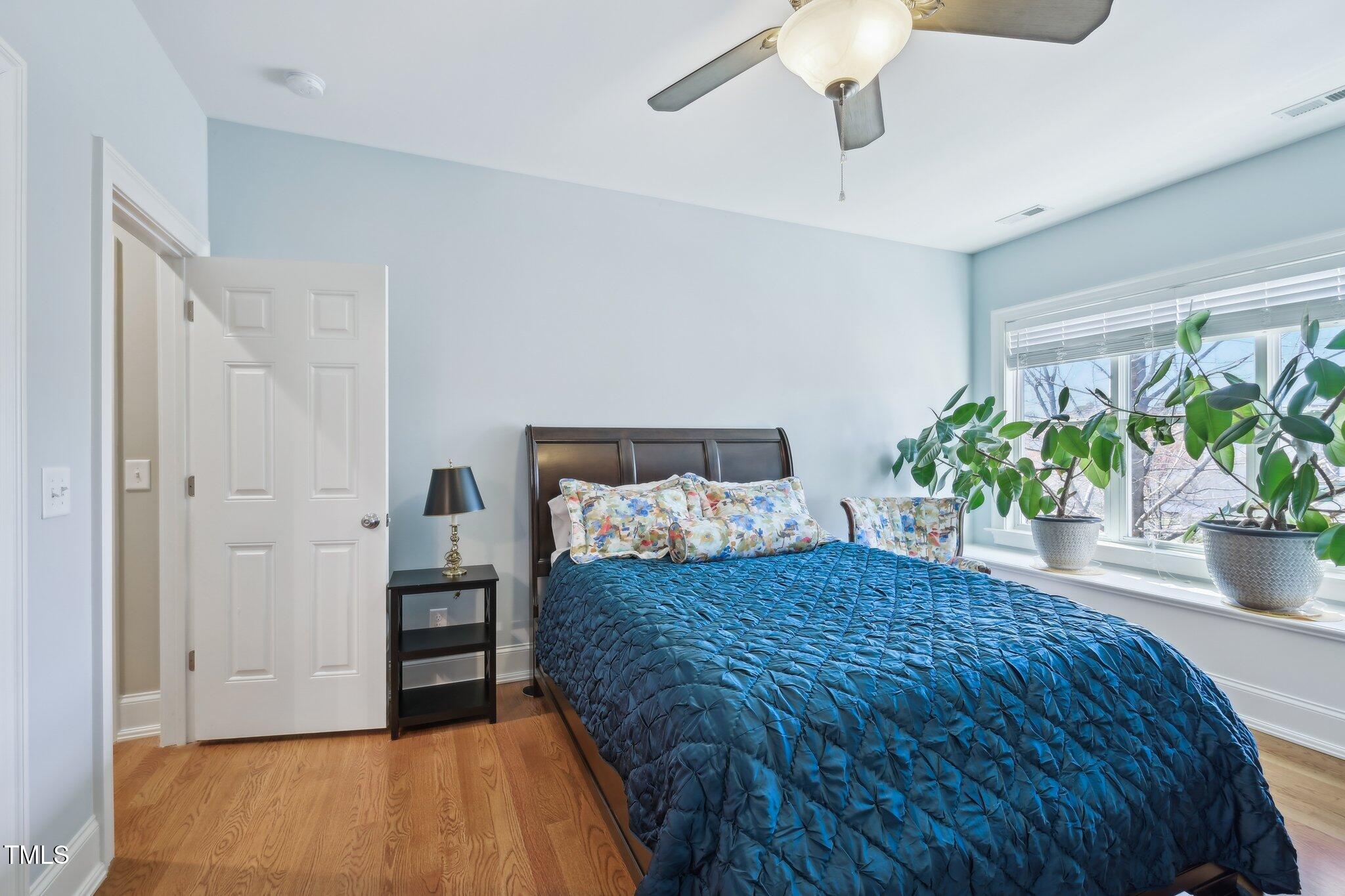 301 Kinsale Drive Durham, NC 27707 - Photo 46 of 68 a bedroom with a bed and a potted plant